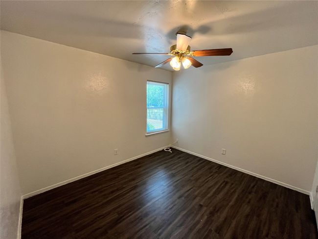 This is a nice sized bedroom. Notice the beautiful flooring. | Image 9