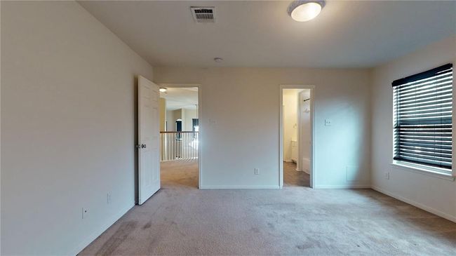 Inviting guest bedroom with ample natural light, perfect for relaxation. | Image 33