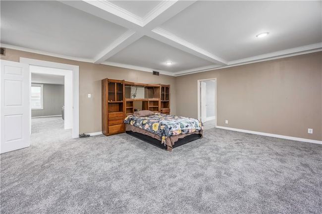 Bedroom with beam ceiling, carpet, baseboards, and ornamental molding | Image 36