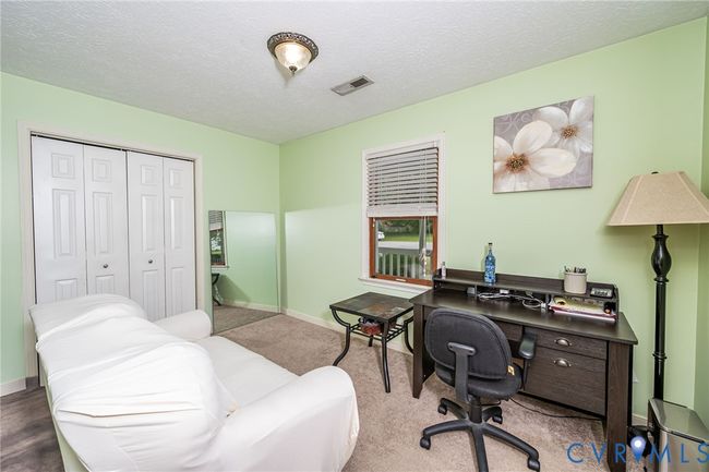 Office featuring a textured ceiling and carpet | Image 13