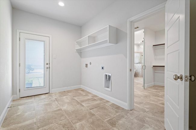 Laundry area featuring electric dryer hookup and hookup for a washing machine | Image 29