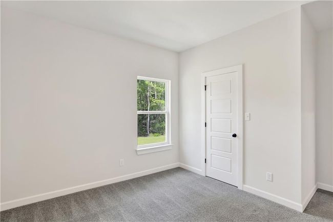 Carpeted empty room featuring baseboards | Image 20