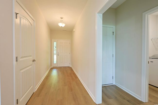 Hallway featuring light wood-style floors and washer / clothes dryer | Image 16