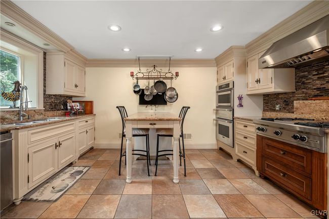 Eat-in kitchen; warming drawer; custom cabinets; tile floor | Image 11