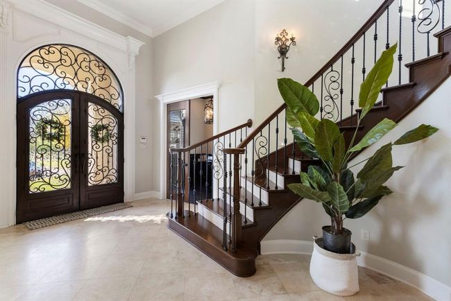 Grand Triple-Height Entryway with Elegant Spiral Staircase | Image 5