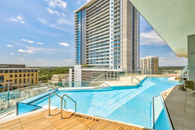 Community pool featuring a patio, pingpong tables, entertainment area for watching sports by the pool | Image 21