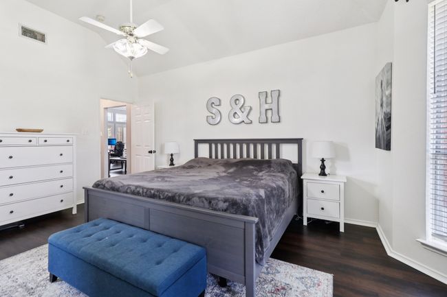 Bedroom with dark wood-style floors, lofted ceiling, baseboards, and ceiling fan | Image 18