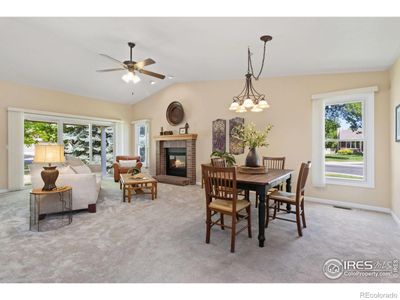 Living room with gas log brick fireplace and dining room. Plus, sliding doors to back patio. | Image 2