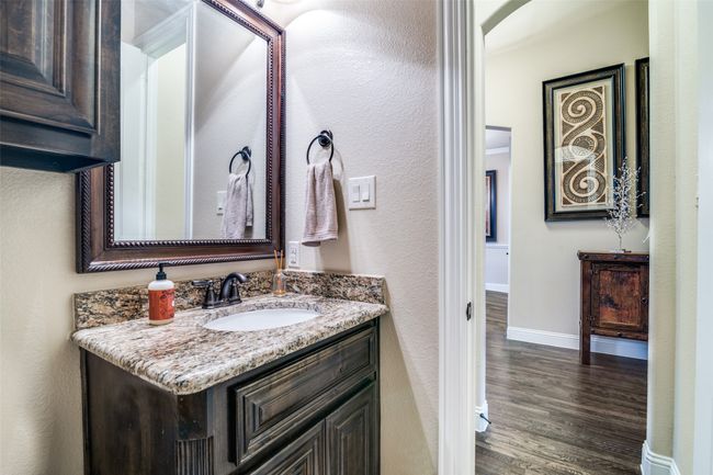 The half bath is conveniently located off of the entry hall. It is also designed with the same designer features that are consistent through all bathrooms. | Image 26