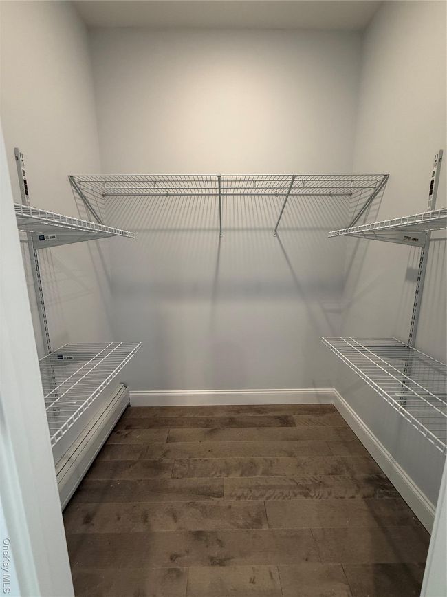 Walk in closet featuring hardwood / wood-style floors | Image 17