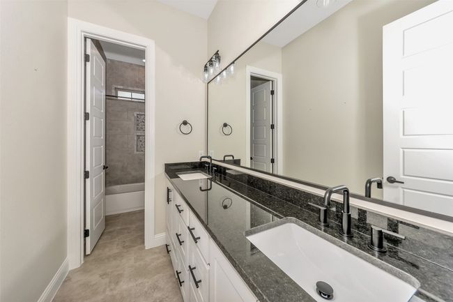 Full bath featuring a sink, baseboards, and double vanity | Image 28