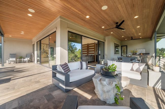 View of patio featuring an outdoor living space, ceiling fan, and exterior kitchen | Image 28
