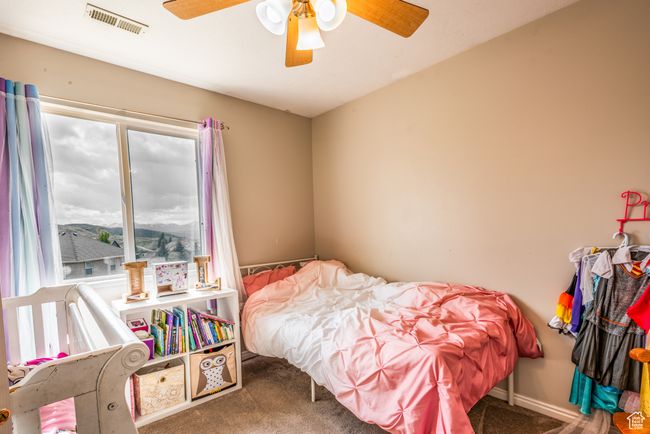 Carpeted bedroom featuring a ceiling fan | Image 23