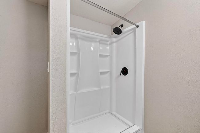 Bathroom with a shower and a textured wall | Image 20