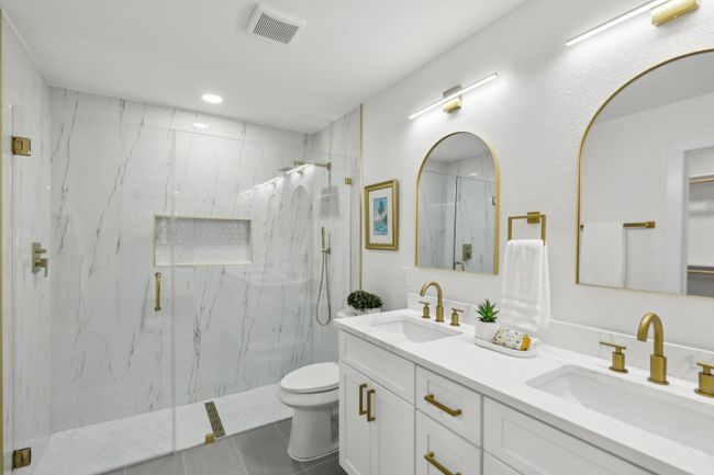 Full bath featuring visible vents, toilet, a sink, and a marble finish shower | Image 13
