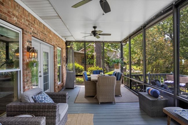 Sunroom featuring a healthy amount of sunlight, outdoor dining space, and ceiling fan | Image 26
