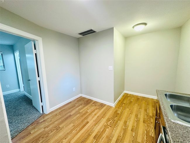 Unfurnished room with light wood-style floors and a sink | Image 8