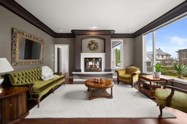Living room featuring a glass covered fireplace and ornamental molding | Image 5