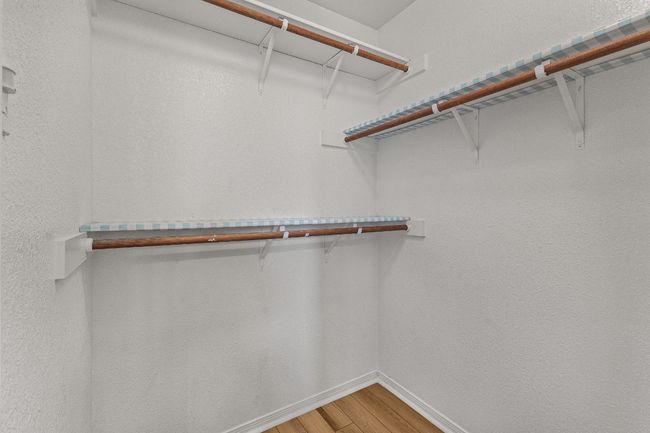 Walk in closet featuring light wood-type flooring | Image 13