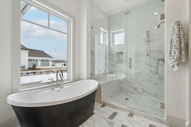 Bathroom with a freestanding bath, marble finish floor, and a marble finish shower | Image 26