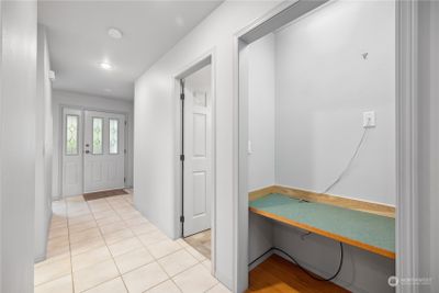 Hallway with desk nook and looking towards front door. | Image 3