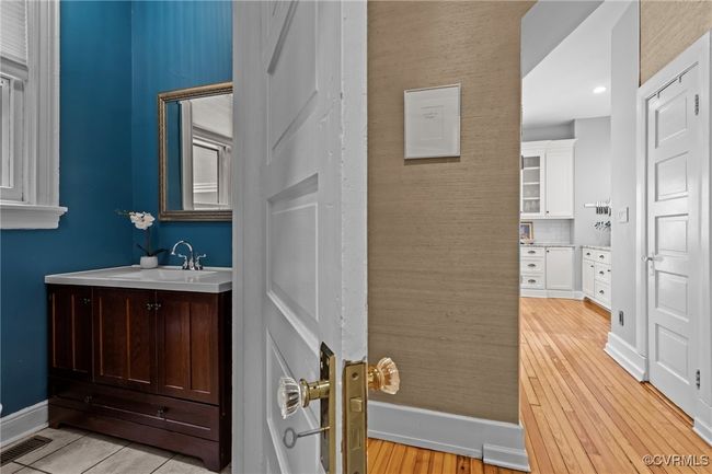 Bathroom featuring baseboards, wood finished floors, visible vents, and vanity | Image 10