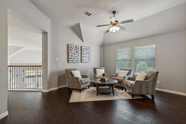 Living room with a healthy amount of sunlight, lofted ceiling, ceiling fan, and dark wood-type flooring | Image 19