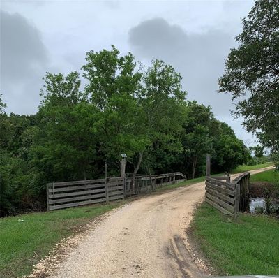 Bridge over creek to get to the home | Image 2