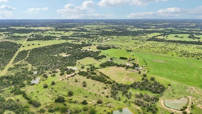 Aerial view of sparsely populated area with a large body of water | Image 21
