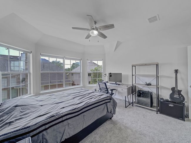 Carpeted bedroom with ceiling fan | Image 23