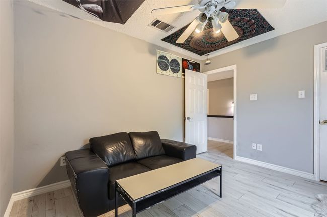 Living area featuring ceiling fan, light wood-type flooring, and baseboards | Image 23