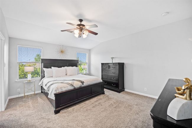 Bedroom featuring carpet floors, a ceiling fan, and vaulted ceiling | Image 13