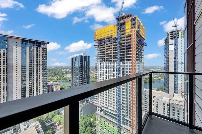 Balcony with a water view and a view of city | Image 17