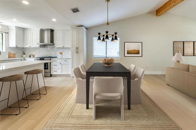 Dining area featuring recessed lighting, lofted ceiling with beams, light wood-style flooring, a chandelier, and visible vents | Image 4
