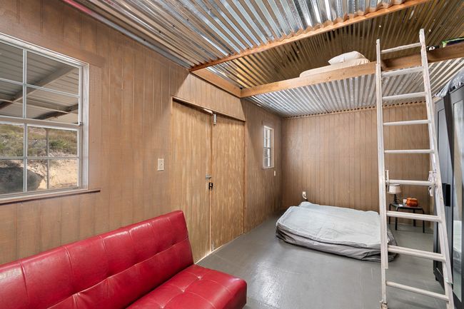 Unfurnished bedroom featuring wooden walls | Image 10
