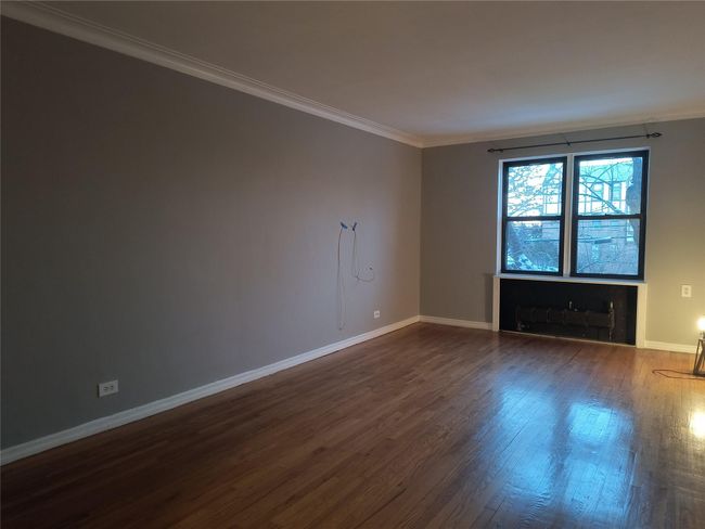 Unfurnished room featuring dark wood finished floors, baseboards, and ornamental molding | Image 39
