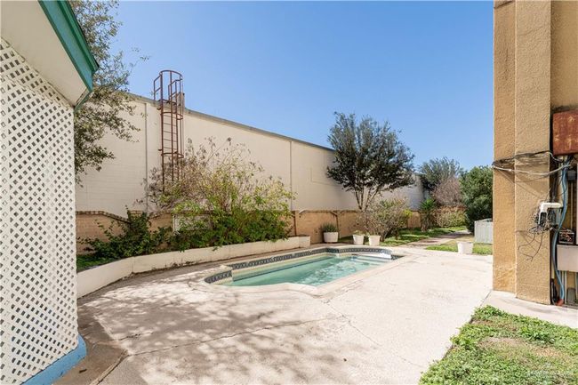 View of swimming pool featuring an outdoor hot tub and a patio | Image 4