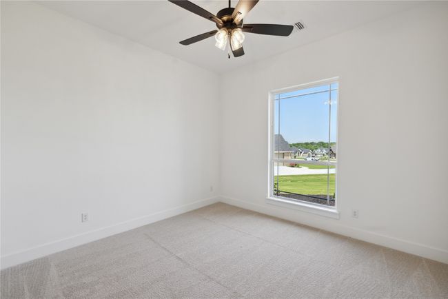 Unfurnished room with light colored carpet and ceiling fan | Image 25