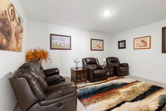 Cozy upstairs media room with plush seating and stylish decor, perfect for entertainment and relaxation. | Image 39