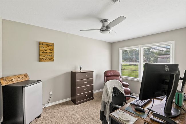 Office area with ceiling fan and light carpet | Image 15