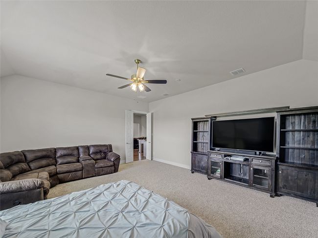 Carpeted bedroom featuring lofted ceiling and a ceiling fan | Image 31