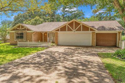 Charming single-story home featuring a welcoming front porch and a two-car garage | Image 1