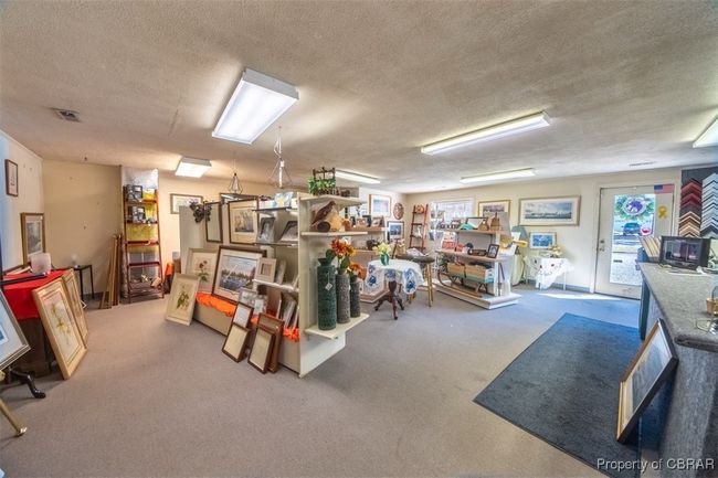 Below grade area with a textured ceiling and carpet floors | Image 7