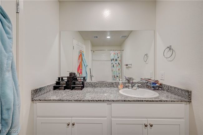 Bathroom featuring vanity and a shower with curtain | Image 23