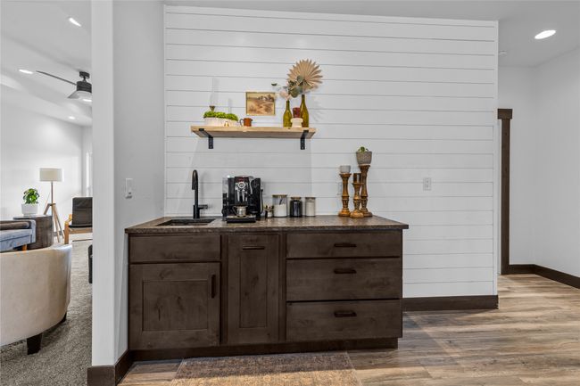 Bar with recessed lighting, a sink, bar area, baseboards, and wood finished floors | Image 9