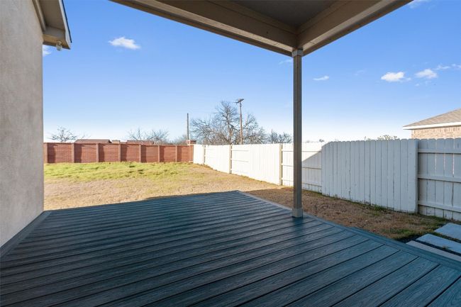 Deck featuring a fenced backyard and a lawn | Image 33