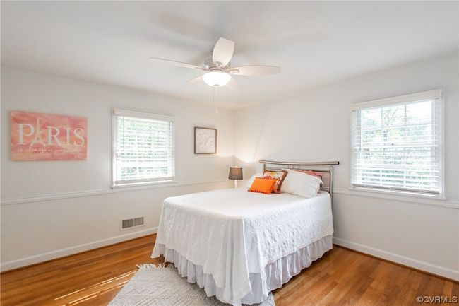 Bedroom with closet, ceiling fan, custom window blinds, and refinished hardwood floor | Image 21