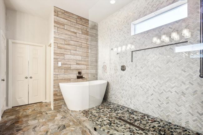 Remodeled Primary Bathroom with tile walls, tile patterned flooring, and independent shower and bath | Image 15