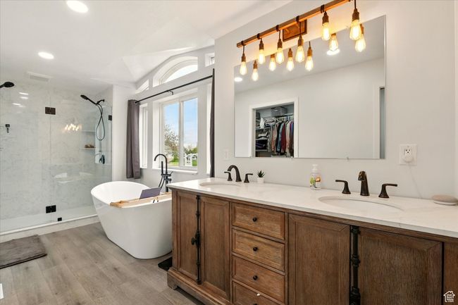 Full bathroom with a shower stall, a soaking tub, double vanity, wood finished floors, and recessed lighting | Image 18
