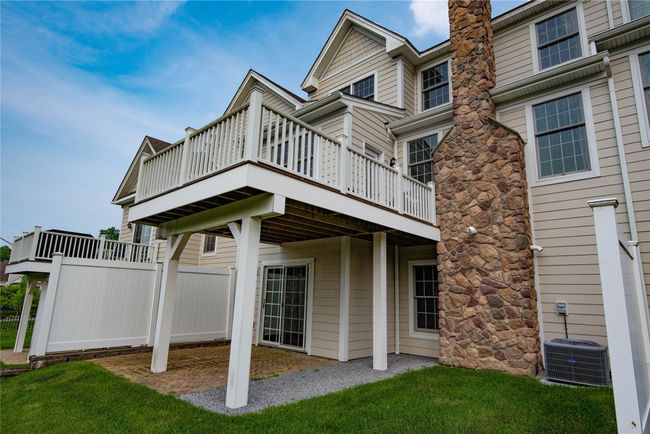 Rear view of house with a wooden deck | Image 19